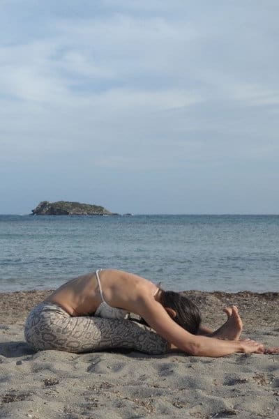 Opale in pascimottanasana caterpillar Yin Yoga pose Restorative yoga by the sea Ibiza
